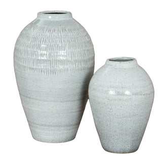 Two light blue speckled ceramic vases, medium and large, displayed together for scale.