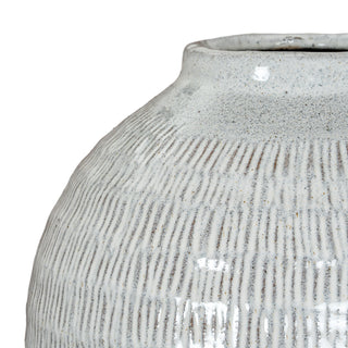 Detailed view of the ceramic vase where the textured body curves inward towards the rim.