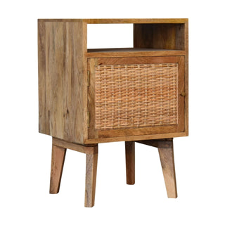 Close view highlighting the rustic mango wood grain and the texture of the woven rattan cupboard door.