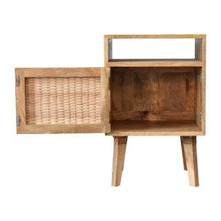 Wooden bedside table with the woven rattan door open, showing the internal storage compartment.