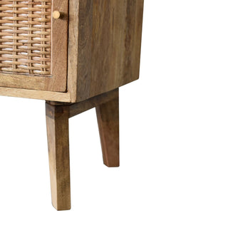 Close-up of the tapered wooden legs and the lower corner of the bedside cabinet, showing the mango wood grain.