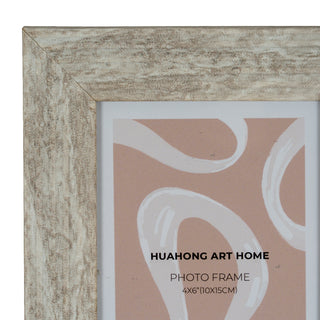 Close-up detail of the top-left mitred corner showing the distressed, pale wood grain texture.