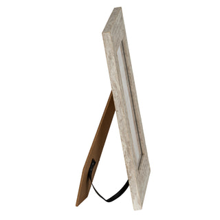 Profile view of the light wood frame standing on its easel back, secured by a black fabric strap.