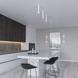 Three white ceiling lamps installed over a marble kitchen island in a modern interior.