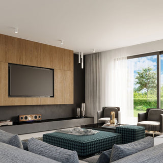 Surface-mounted and suspended cylindrical white lights illuminating a modern living room with wood panelling.