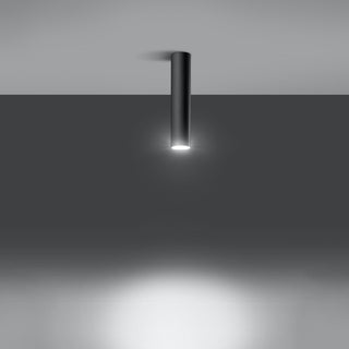 Black cylindrical ceiling lamp fixture demonstrating its focused downward beam of white light.