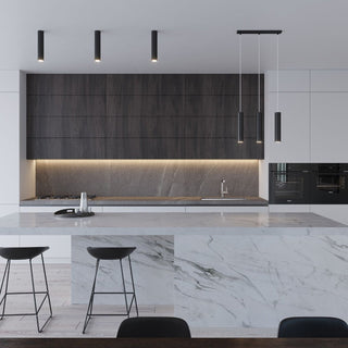 Black cylindrical lamps surface mounted above dark kitchen cabinets, paired with matching pendant lights.