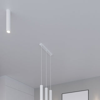 Single cylindrical ceiling light next to a triple pendant light cluster.