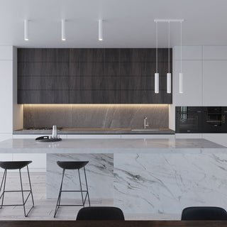 Three cylindrical pendant lights and three surface downlights in a contemporary kitchen.