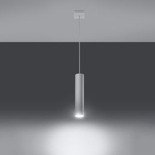 Cylindrical pendant lamp illuminated, showing a bright downward spotlight beam against a dark background.