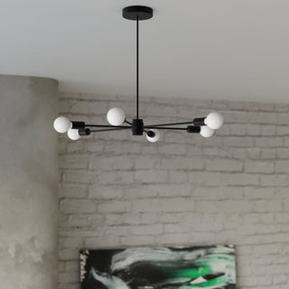 Six-light black chandelier suspended against a background of painted brick and rough textured walls.