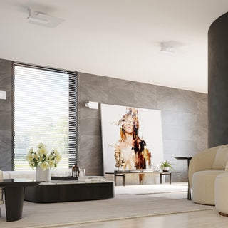 White lamps installed as ceiling and wall fixtures in a contemporary room with slate grey tiled walls.