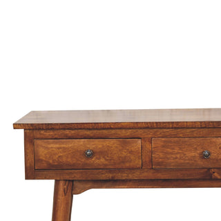 Close-up of the chestnut console table showing the wood grain, two drawers, and round metal knobs.