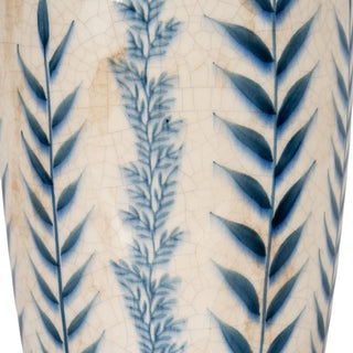 Close detail of the vase body showing vertical blue leaf and fern patterns on the cream crackle glaze surface.
