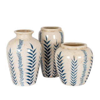 Grouping of three cream crackle glaze vases with blue leaf patterns, showing different sizes and shapes.