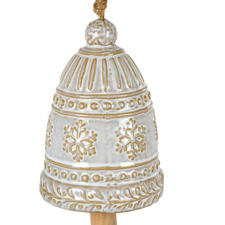 Detailed view of the white ceramic bell ornament with gold embossed snowflakes and decorative bands.