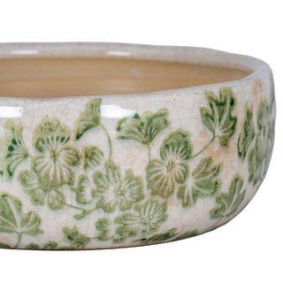 Detailed view of the bowl's side, showing the cream crackle glaze and hand-painted green clover design.