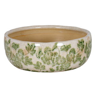 Shallow ceramic bowl with cream crackle glaze and green clover leaf pattern.