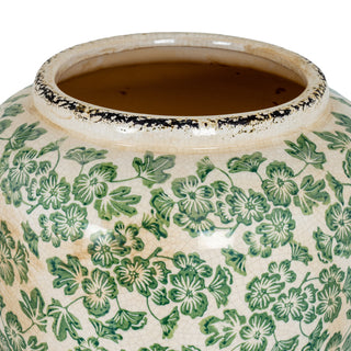 Close-up of the vase mouth, showing the dark interior glaze, distressed black rim, and the green clover pattern detail.