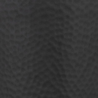 Detailed view of the matt black hammered metal surface texture.