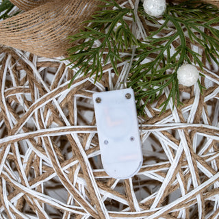 Detail of the white plastic battery casing for the LED lights on the interwoven rattan.