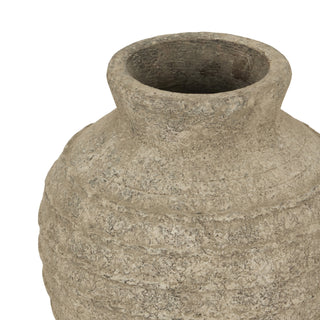 Close-up of the textured grey vase neck and rim, highlighting the rough, pitted finish.
