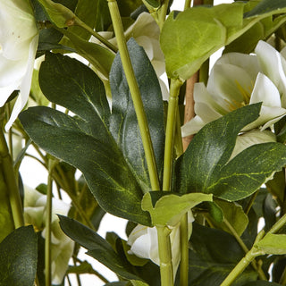 Detailed close-up of the artificial hellebore foliage, stems, and white flowers.