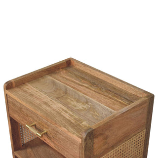 Detail shot of the bedside cabinet's wooden top surface featuring a raised lip and visible mango wood grain.
