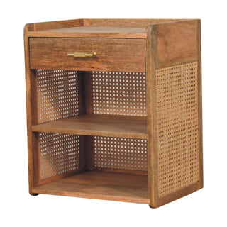 Angled view of the wooden nightstand featuring a drawer, brass handle, and open shelving with cane panels.