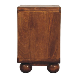 Side profile of the chestnut nightstand highlighting the wood grain and chunky ball feet.