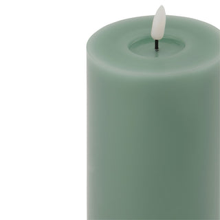 Close-up detail of the sage LED pillar candle top, showing the faux melted depression and the white plastic flickering flame element.