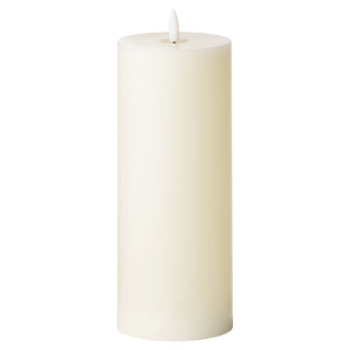 Tall cream LED wax pillar candle with a faux flame element, shown in a plain studio shot.