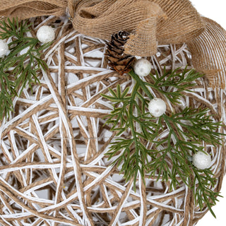 Close-up detail of the interwoven natural and white twine texture, featuring a pinecone and glitter berries.