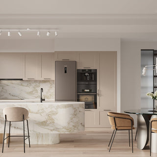 Contemporary kitchen setting featuring a marble island, beige cabinetry, and ceiling track lighting.