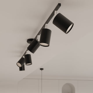 Close perspective view of the black six-spot track light fixture mounted on a white ceiling.