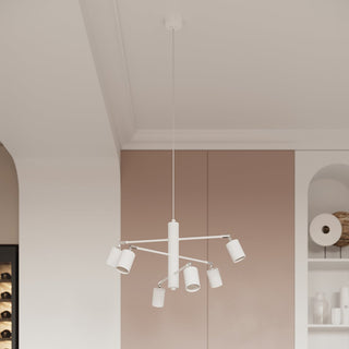 White 6-light chandelier shown in a styled interior with pale pink wall panels and white ceiling trim.