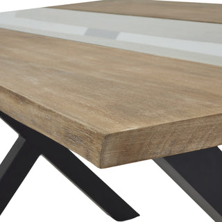 Close-up showing the light acacia tabletop texture, clear resin insert, and black angled metal leg.