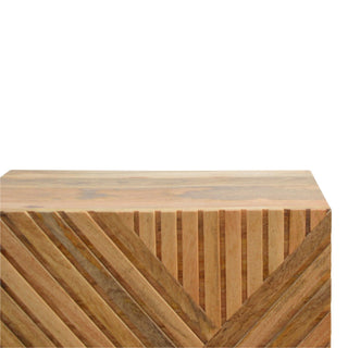 Upper corner detail showing the smooth top edge and the precise intersection of the carved diagonal and vertical lines.