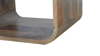 Detail of the mango wood base showing the thickness and smooth U-shaped curve.
