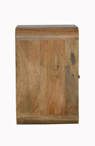 Side view of the mango wood bedside table showing the depth and continuous curve of the top edge.