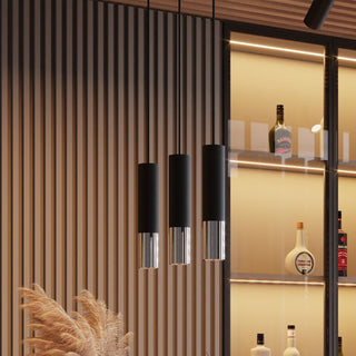 Three matte black and chrome pendants suspended against a textured wooden wall panel and illuminated bar display.