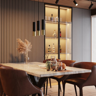 Three black and gold pendant lamps hanging in a cluster over a marble dining table in a styled room scene.