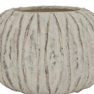 Close up of the squat ceramic vase showing the textured white exterior and the rough, uneven rim.