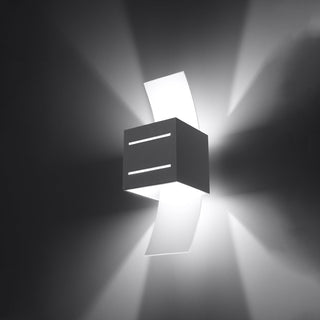 Grey lamp illuminated, demonstrating wide up/down wall wash and narrow light lines from the front slits.