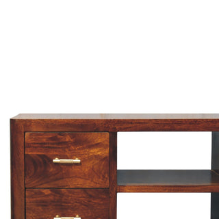 Detail shot of the media unit's top surface, rounded corner, and drawer fronts with brass handles.