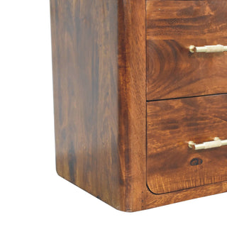 Lower left section detail showing the dark wood grain, rounded corner, and two brass handled drawers.