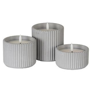 Three ribbed chalk-effect LED candles in different sizes, showing the white faux flames.