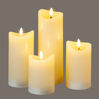 Four glowing cream LED pillar candles of different heights shown against a dark grey background.
