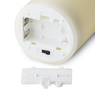 Detail of the LED candle base showing the open battery compartment, contacts, and the power switch.
