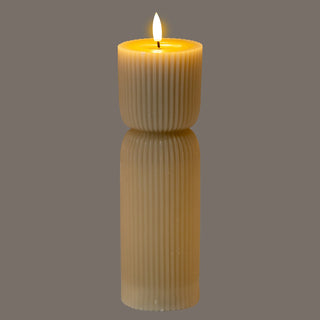 Ribbed, natural stone effect LED candle shown front-on with the flame illuminated.